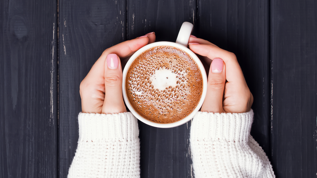 Hands holding a cup of coffee - Dairy and Ice cream - AAK