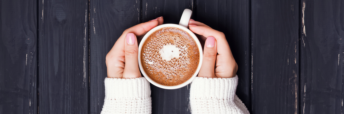 Hands holding a cup of coffee - Dairy and Ice cream - AAK