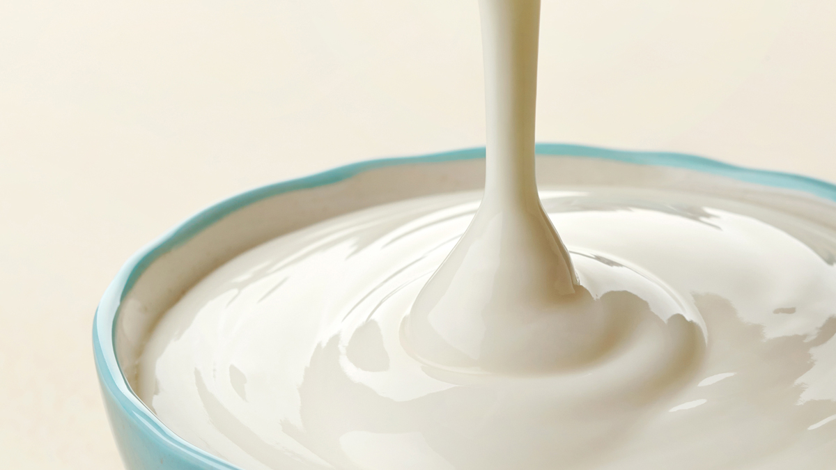 Yoghurt being poured into a bowl - Dairy and Ice cream - AAK